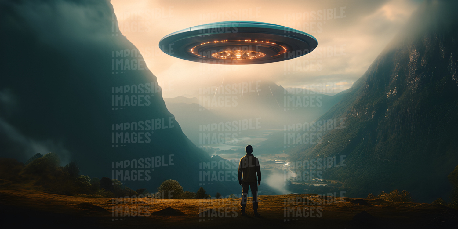 A man stood looking over a valley where a flying saucer hovers in the air -  A man stood gazing out over the valley, his eyes fixed on the flying saucer hovering in the air above.